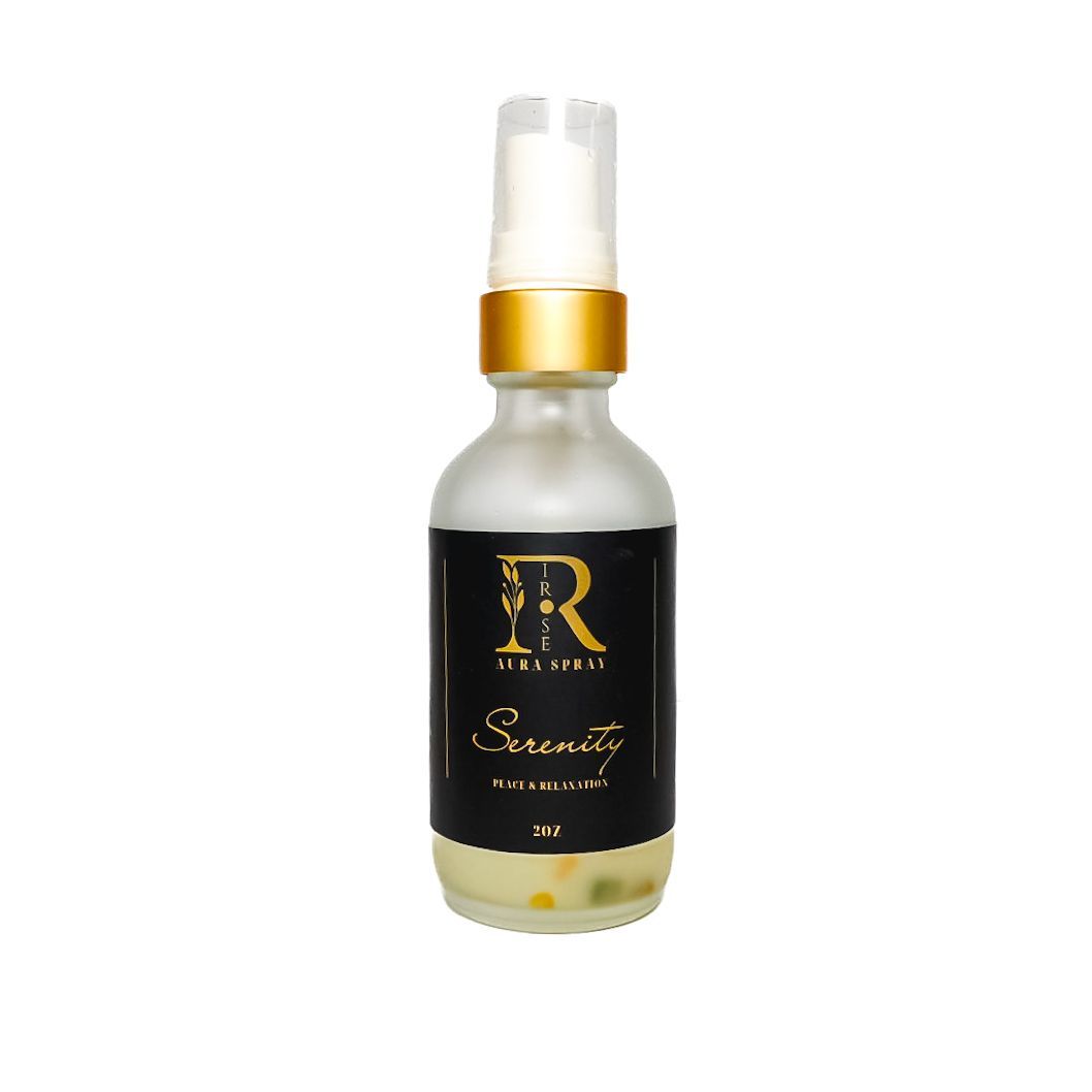 White spray bottle with gold cap and black label reading “Serenity” on a white background
