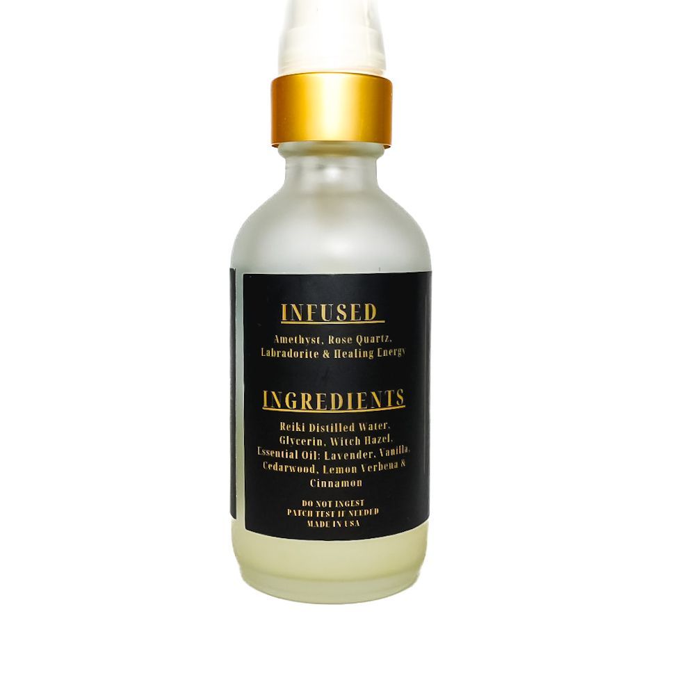 White spray bottle with gold cap and black label reading “Serenity” on a white background