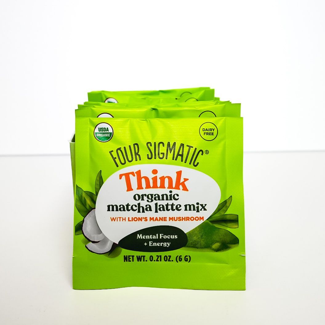 Green Four Sigmatic Think organic matcha latte mix packets with coconut on a white background