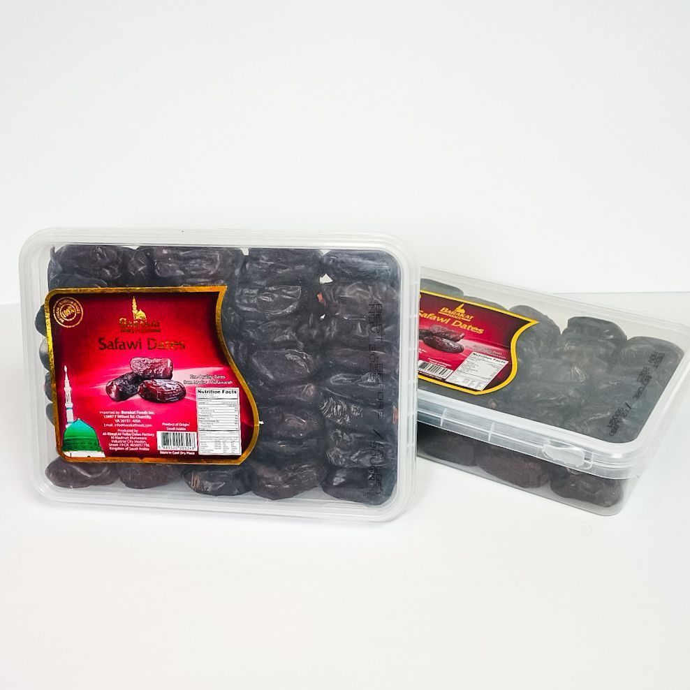 Two clear trays of dark dried dates with red labels on a white background
