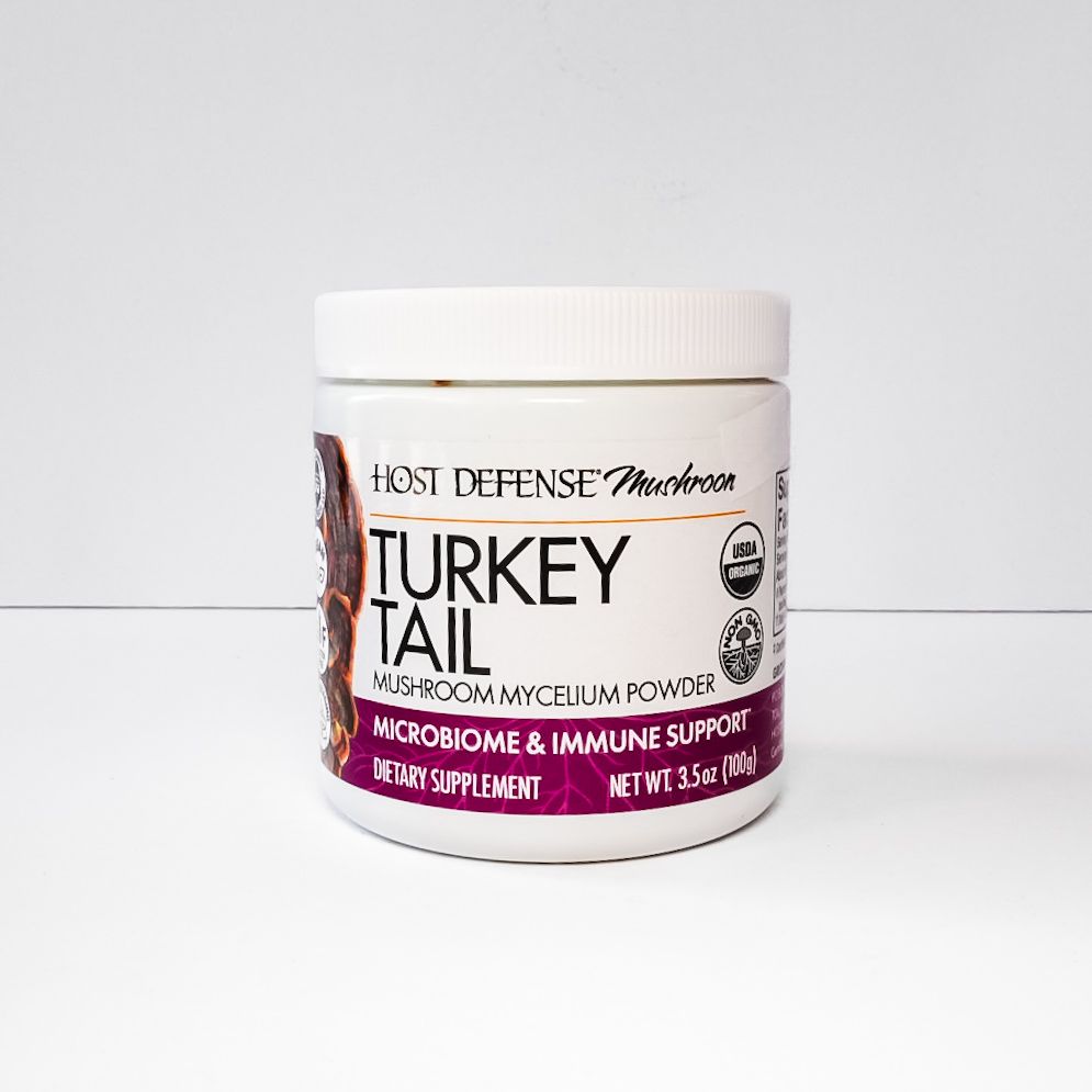 White jar of Host Defense Turkey Tail mushroom supplement on a light background