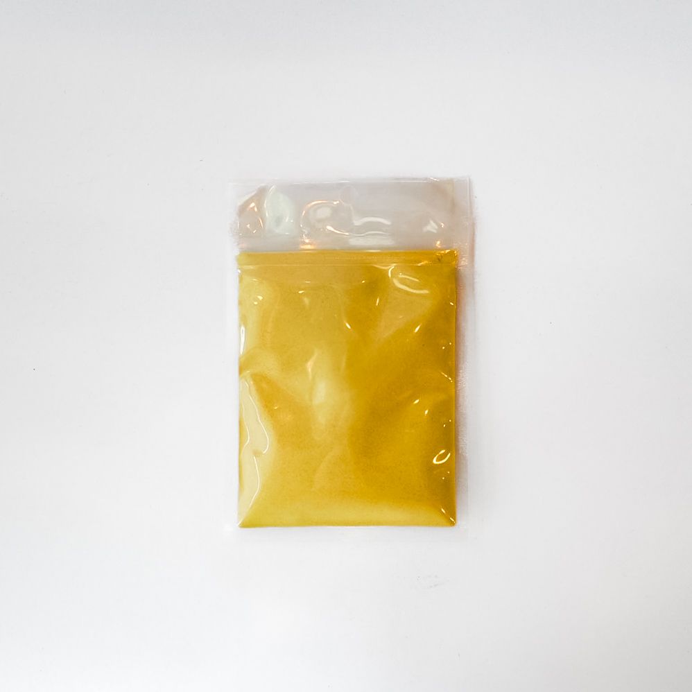 Yellow packaged item with clear top and label on a white background