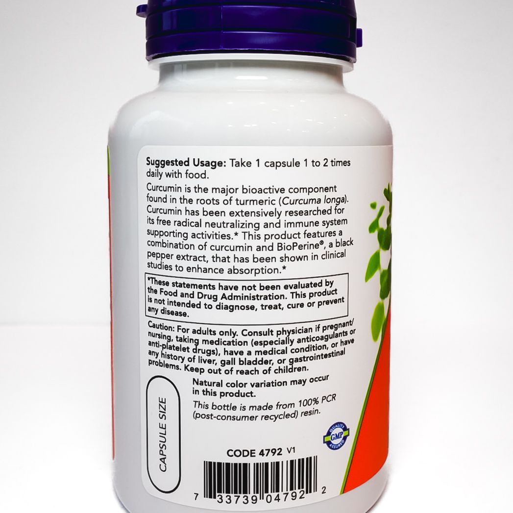 White medicine supplement bottle with purple cap and label text on a plain background