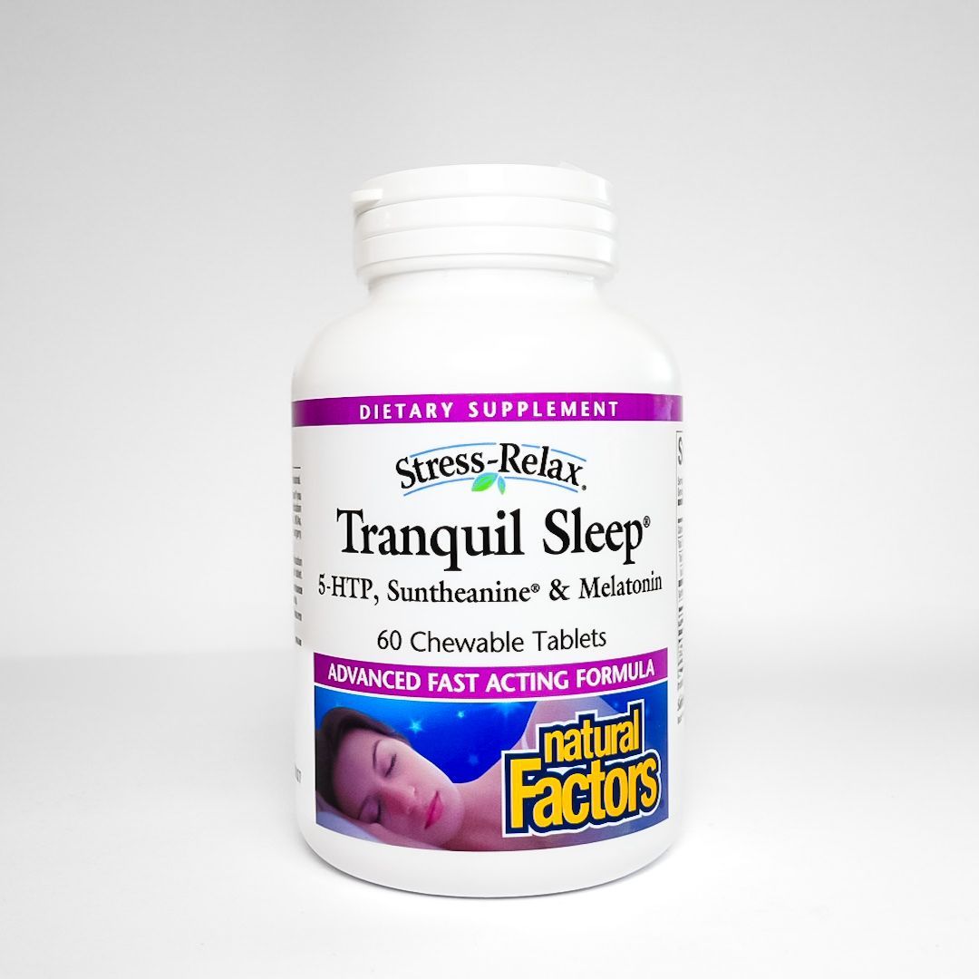 White bottle of Natural Factors Tranquil Sleep dietary supplement tablets on a light background