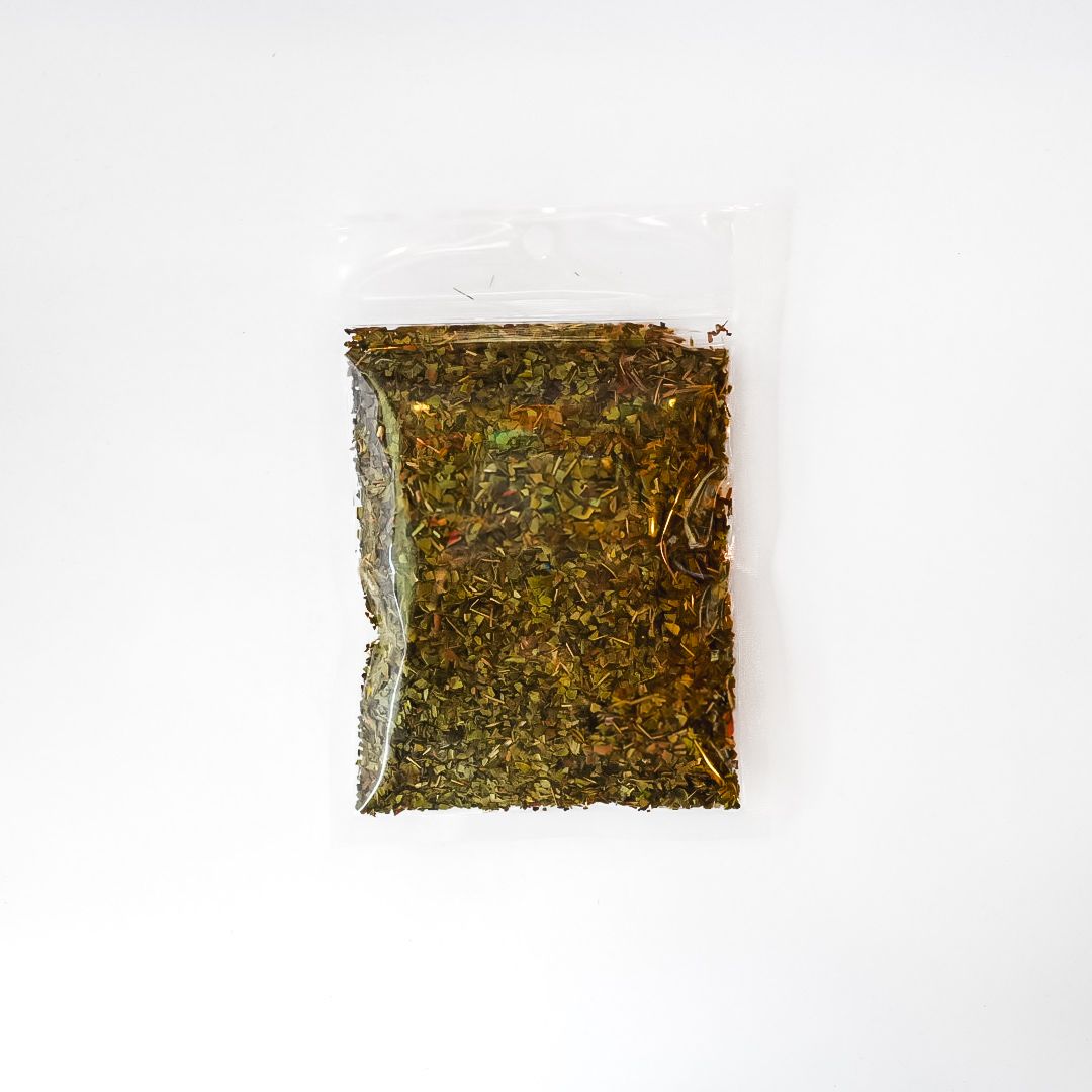 Clear plastic pouch of dried herbs with a bright yellow label on a white background