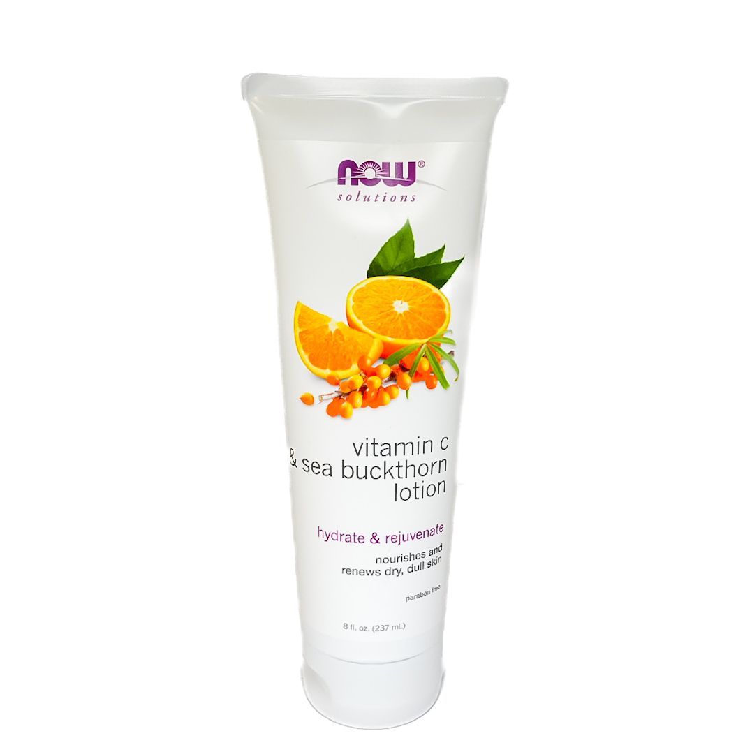 White tube of orange-scented skincare lotion with orange slices and green leaves on the label