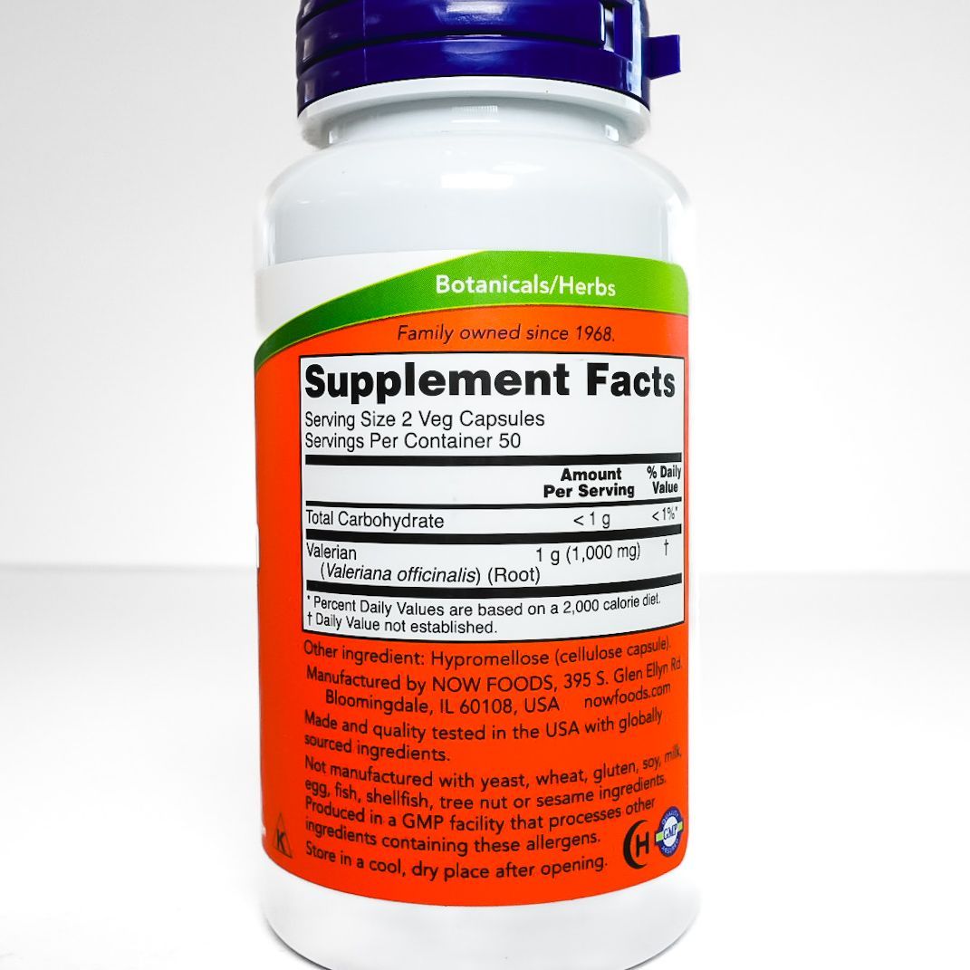 NOW Valerian Root 500 mg supplement bottle with orange label and purple cap