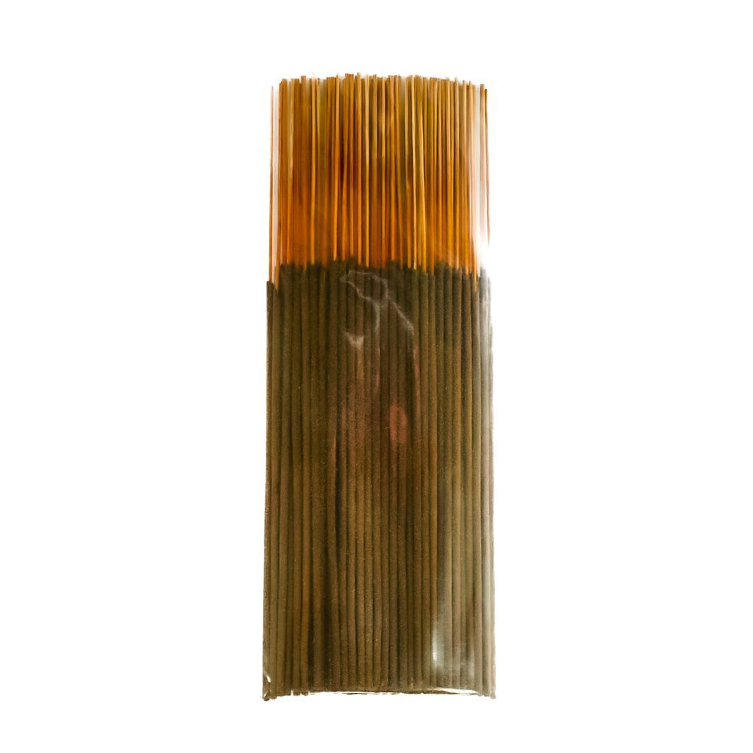 Bundle of brown incense sticks in clear plastic packaging with a yellow label