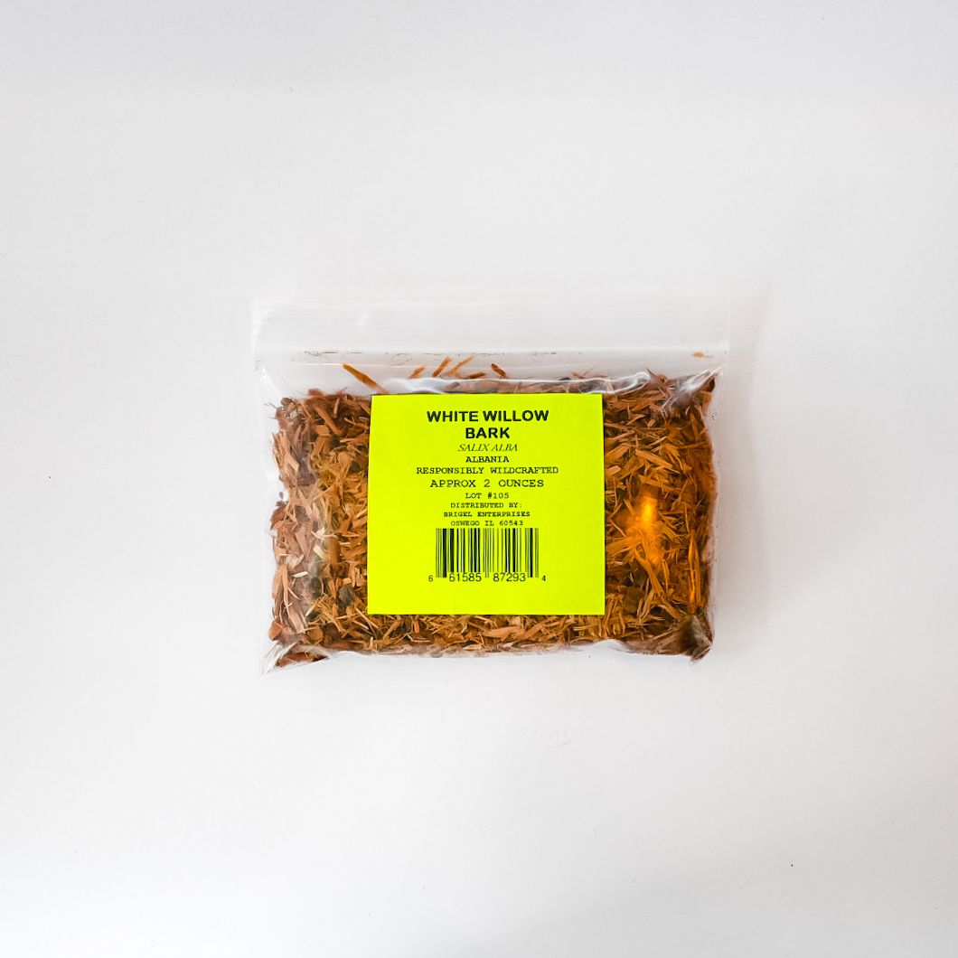 Clear plastic bag of dried nettle leaves with a bright yellow label on a white background