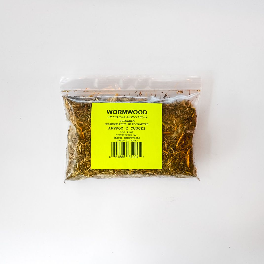 Clear plastic bag of dried herbs with a bright yellow label on a white background
