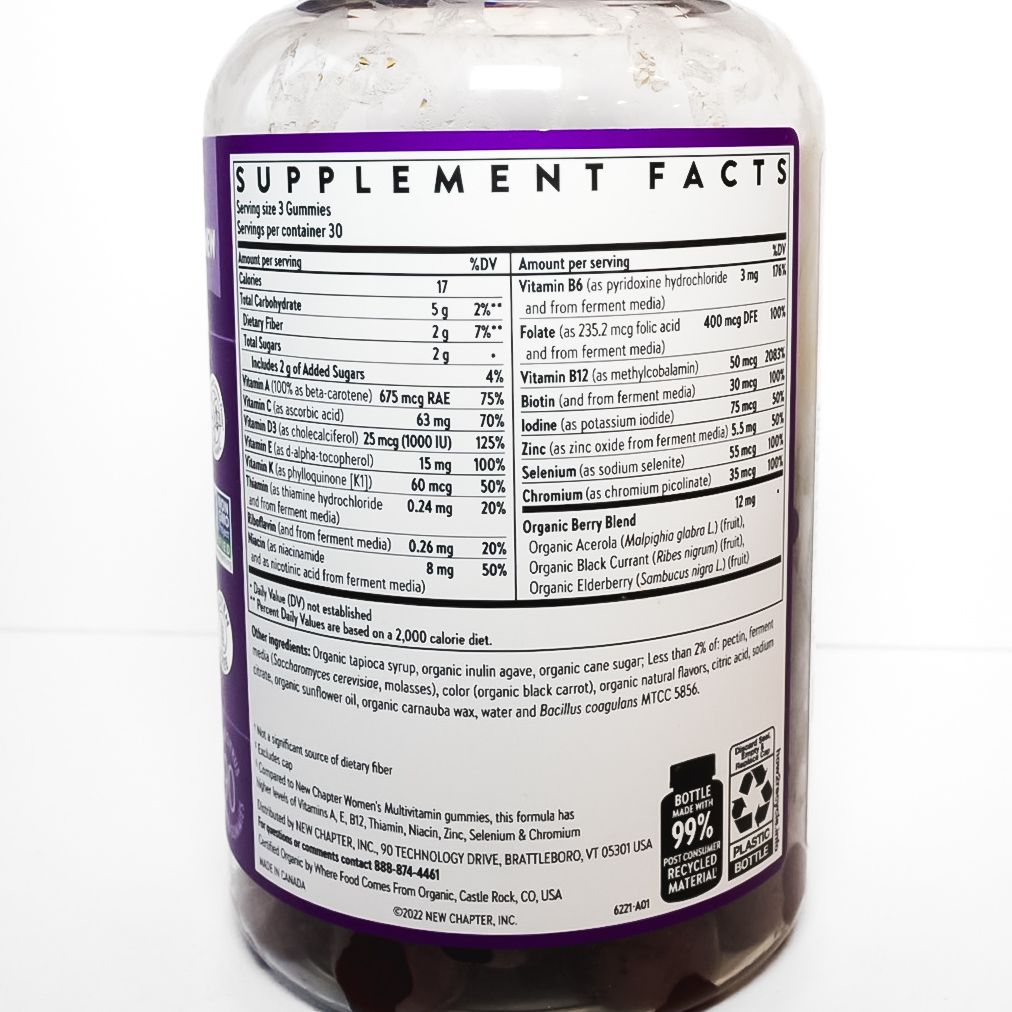Purple New Chapter Women’s 50+ multivitamin bottle with orange capsules on white background