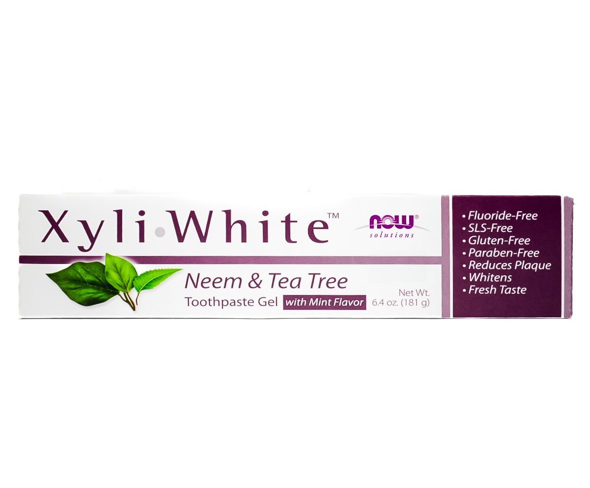 XyliWhite Neem & Tea Tree toothpaste box in white and purple packaging with green leaf graphic
