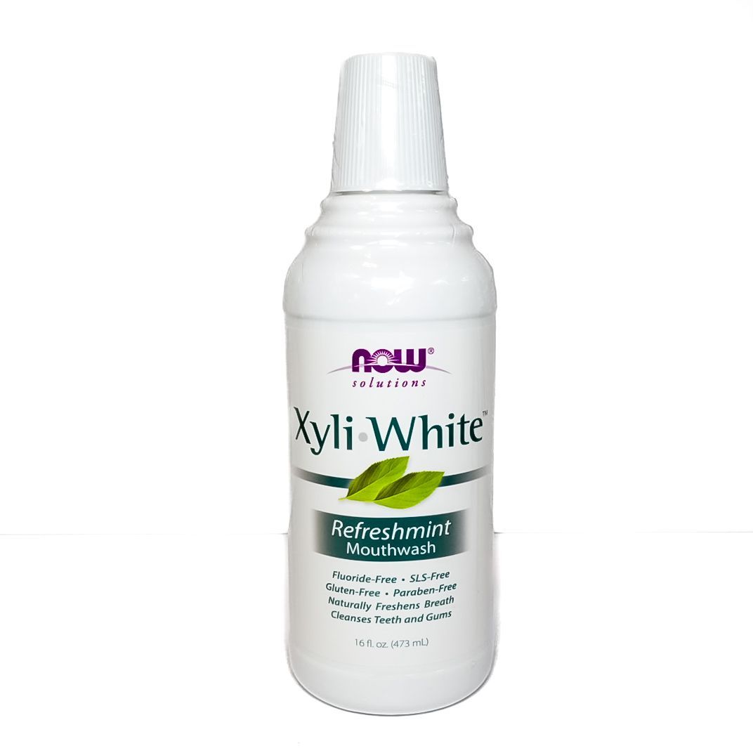 White NOW Xyli-White mouthwash bottle with green accents on a white background