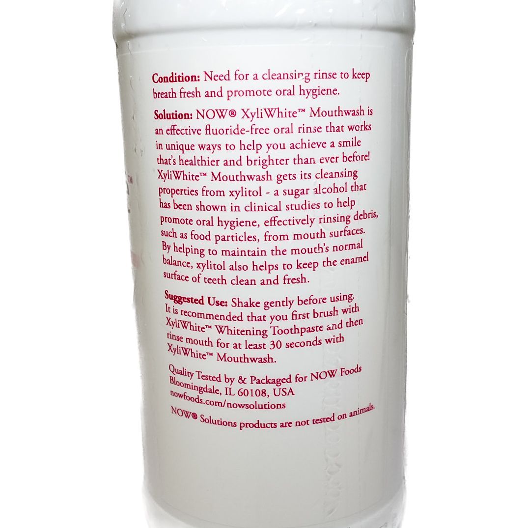 White NOW XyliWhite cinnamon mint toothpaste bottle on a plain background