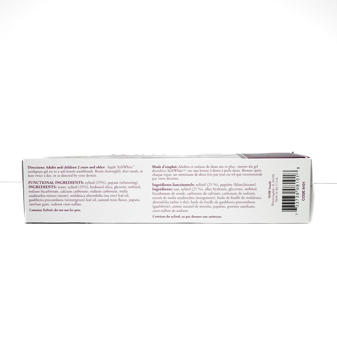 XyliWhite Neem & Tea Tree toothpaste box in white and purple packaging with green leaf graphic