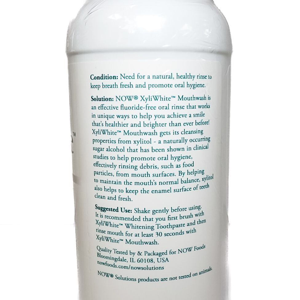 White NOW Xyli-White mouthwash bottle with green accents on a white background