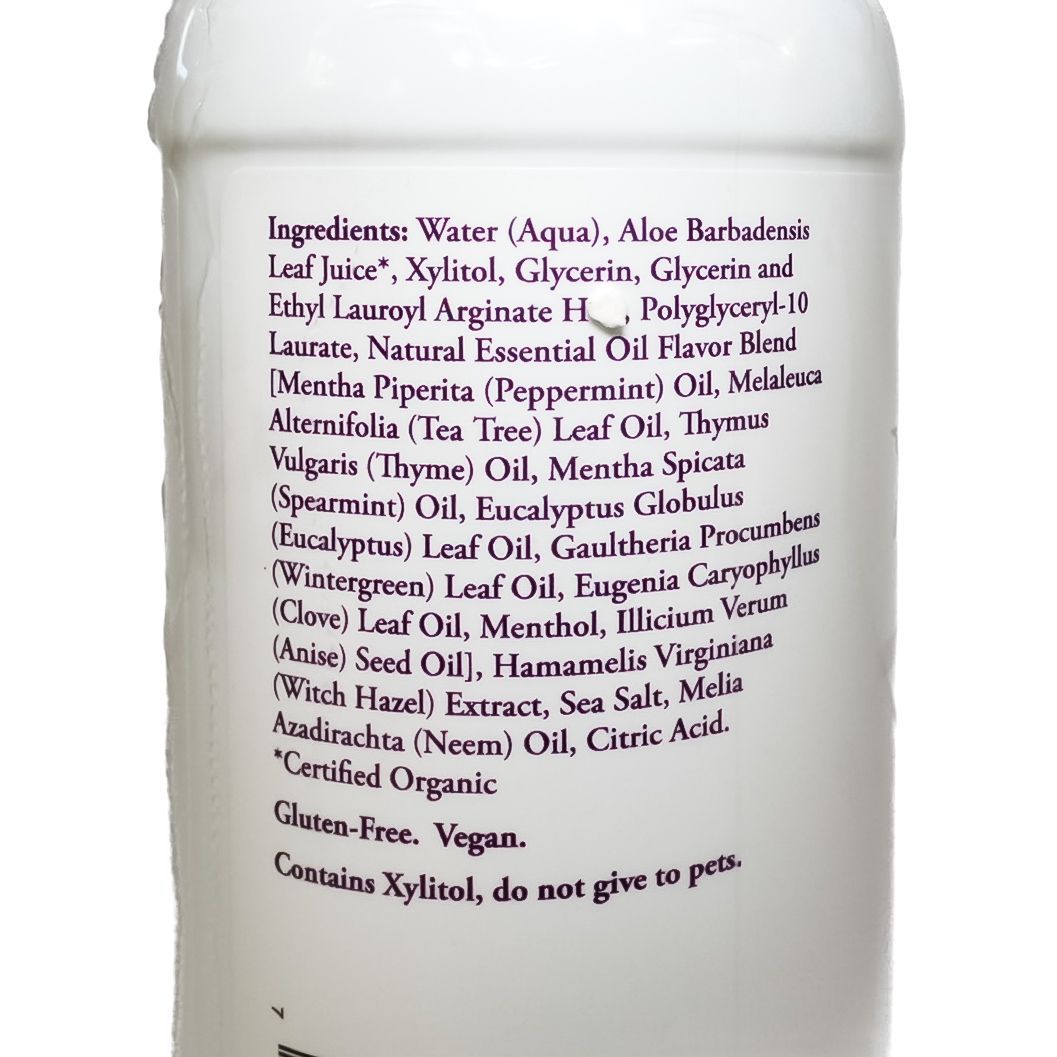 White NOW Xyli-White toothpaste bottle with purple label on a plain background