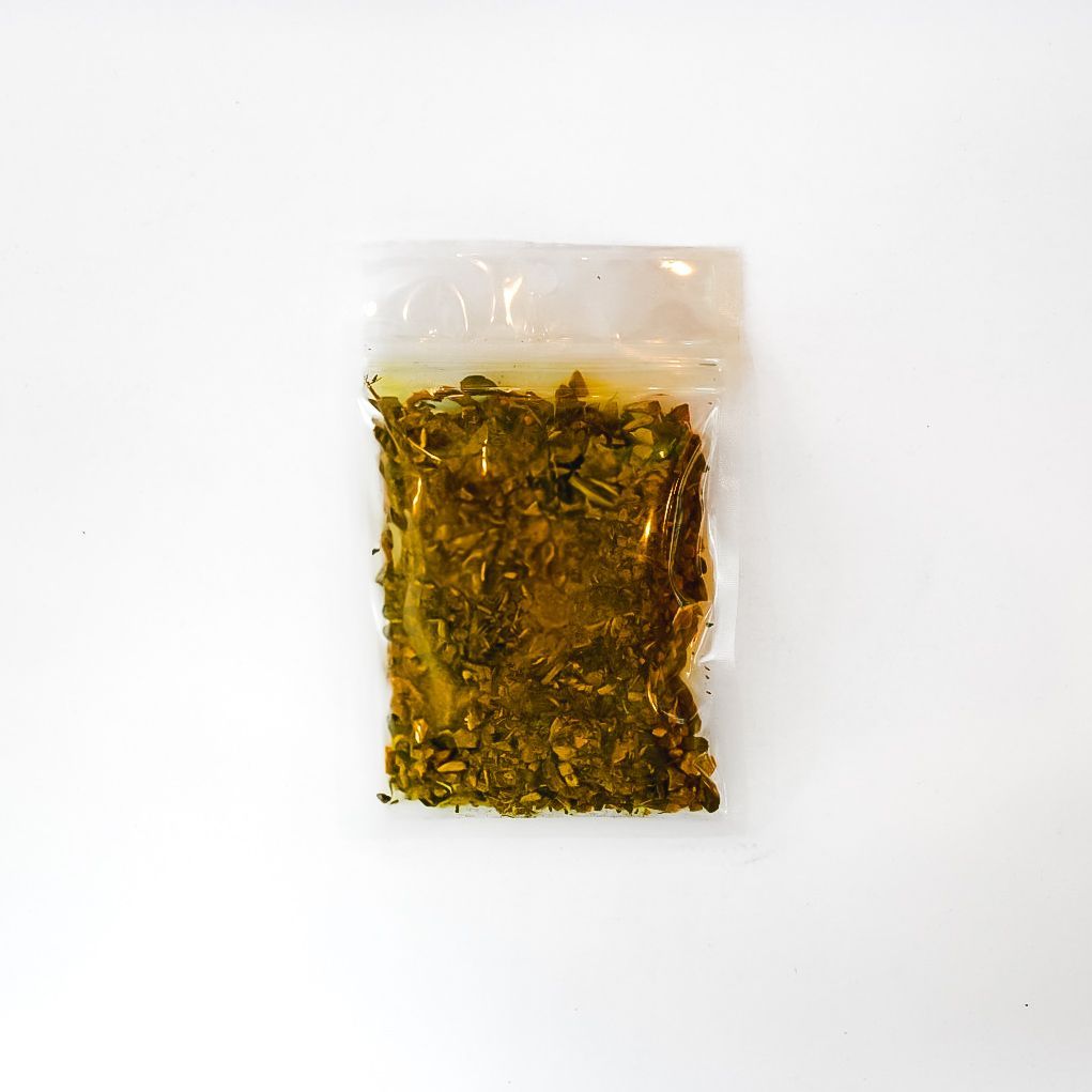 Clear bag of dried yellow dock root with bright yellow label on white background