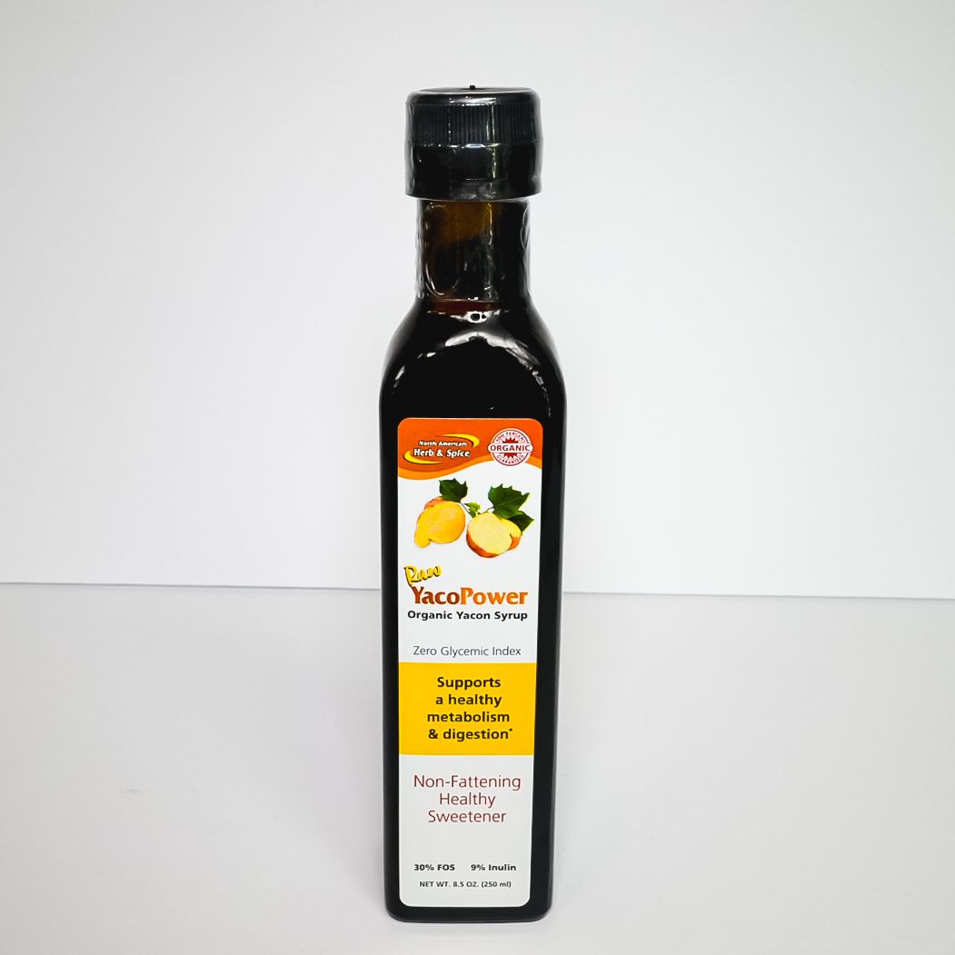 Bottle of dark sauce with a black cap and yellow label, standing on a plain white background