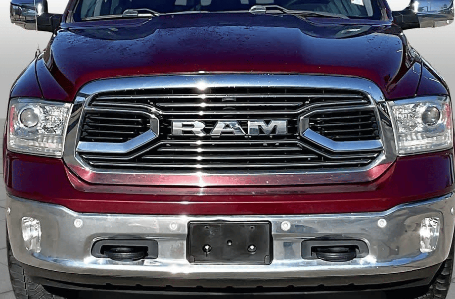 Front view of a maroon RAM truck with chrome grille and bumper