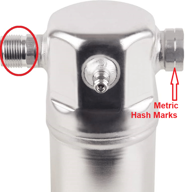 Chrome metal fitting with threaded side ports, red circles highlighting metric hash marks and threads