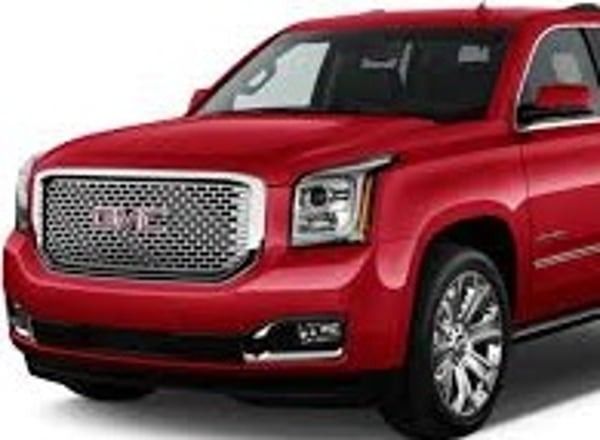 Red GMC SUV with chrome grille, front three-quarter view on white background