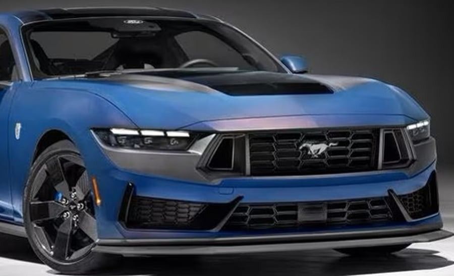 Blue Ford Mustang sports car in a studio, front view with sleek black accents and headlights on