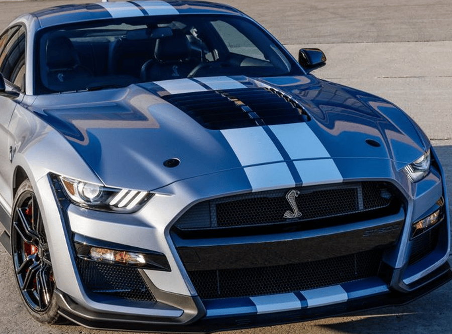 Blue-and-gray Shelby Mustang sports car parked outdoors, front view