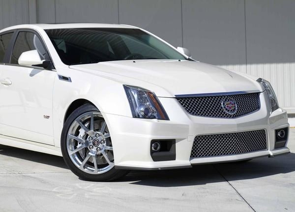 White Cadillac CTS-V coupe parked on a lot, front-left view