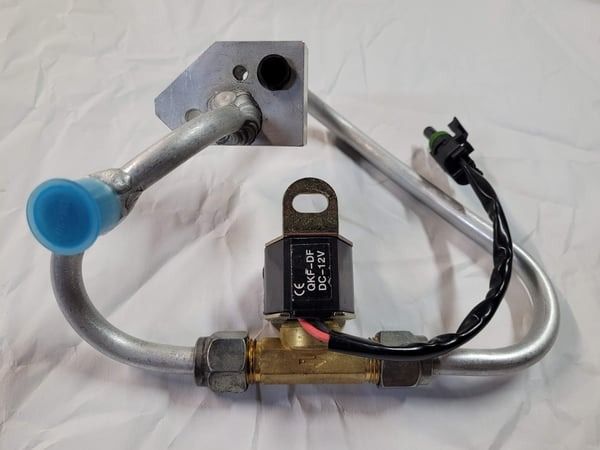Metal tube and brass valve assembly with a blue cap and black wiring on a white background