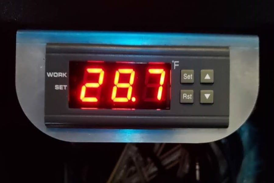Digital temperature controller displaying 28.7°F with red LED numbers and control buttons on the right