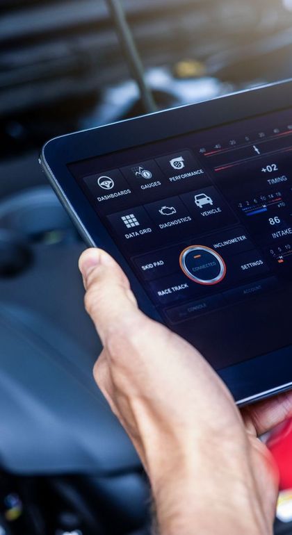 Person holding a tablet displaying vehicle diagnostic | Willamette Automotive Care