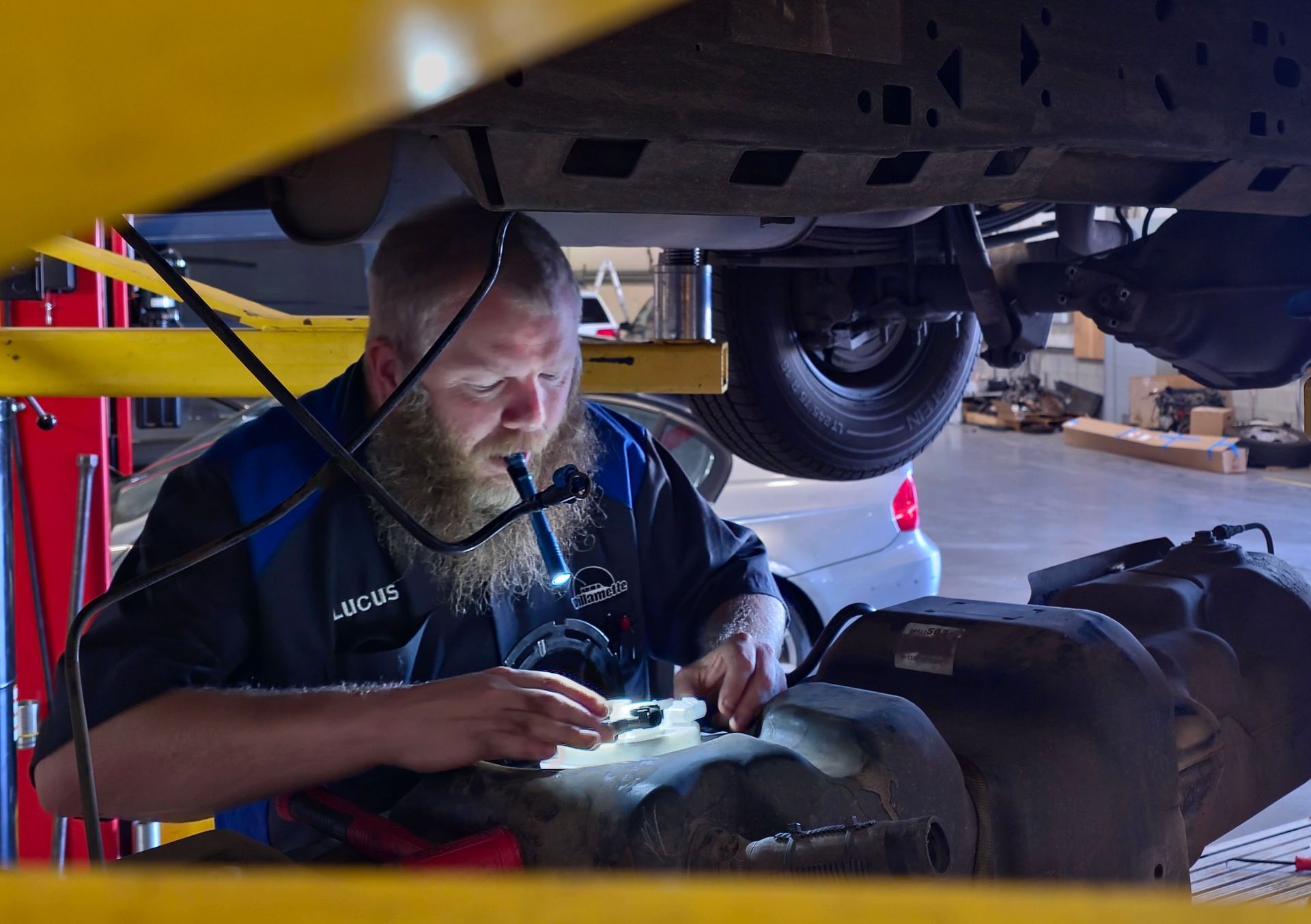 Mechanic examines a vehicle's undercarriage | Willamette Automotive Care