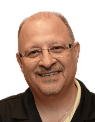 A man wearing glasses and a black shirt is smiling for the camera. the man is dr vastardis dentist from garden city