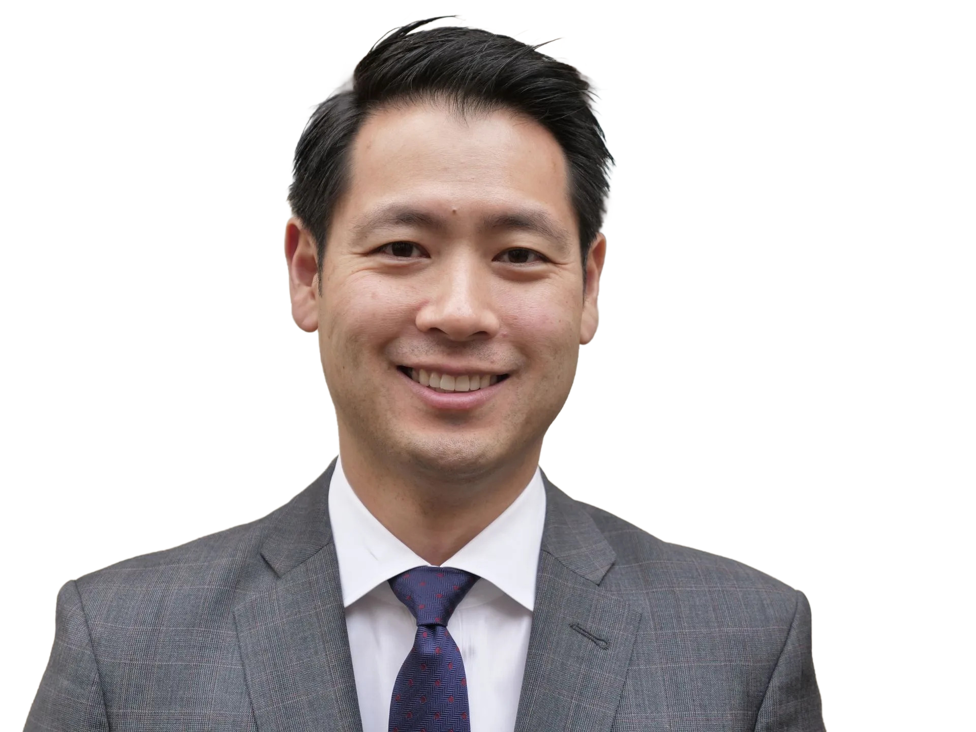 A man in a suit and tie is smiling for the camera. the man is dr. pak dentist from garden city ny