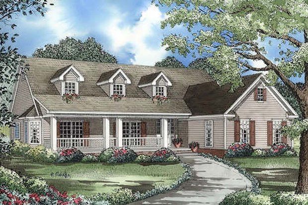 Ranch-style house with a porch, dormers, and a driveway surrounded by landscaping.