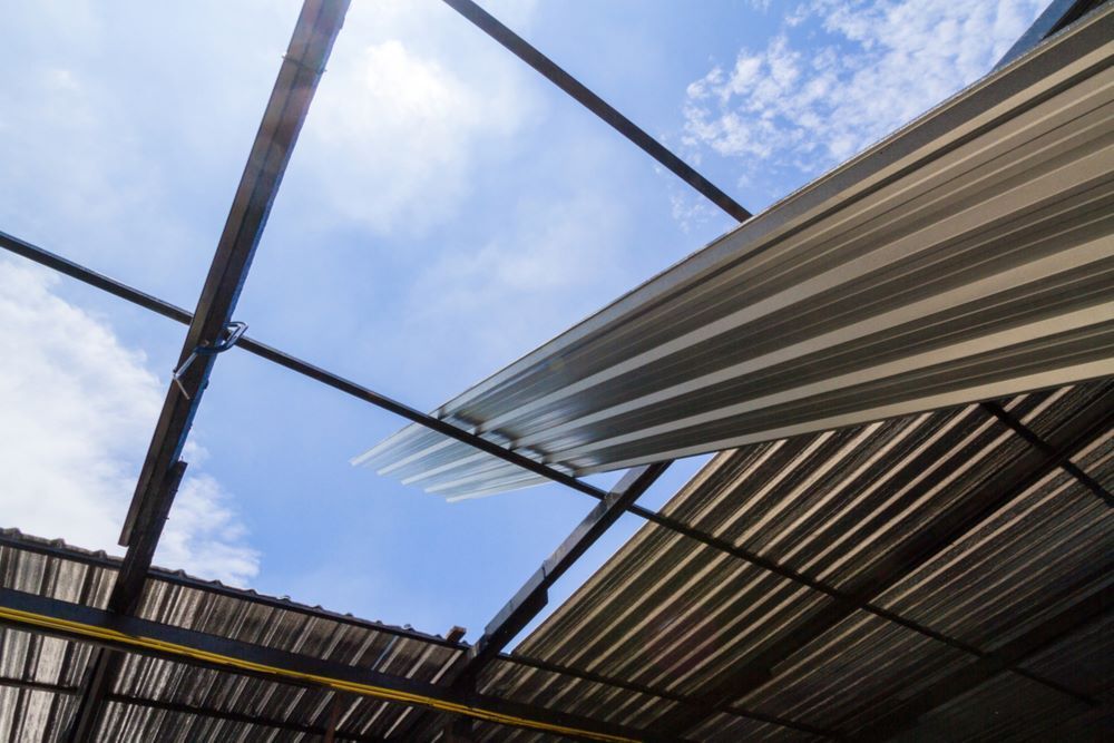 Looking Up at a Metal Roof With a Blue Sky in the Background — Timms Roofing In Barrack Heights, NSW