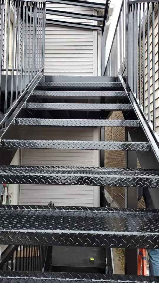 A set of metal stairs leading up to a building.