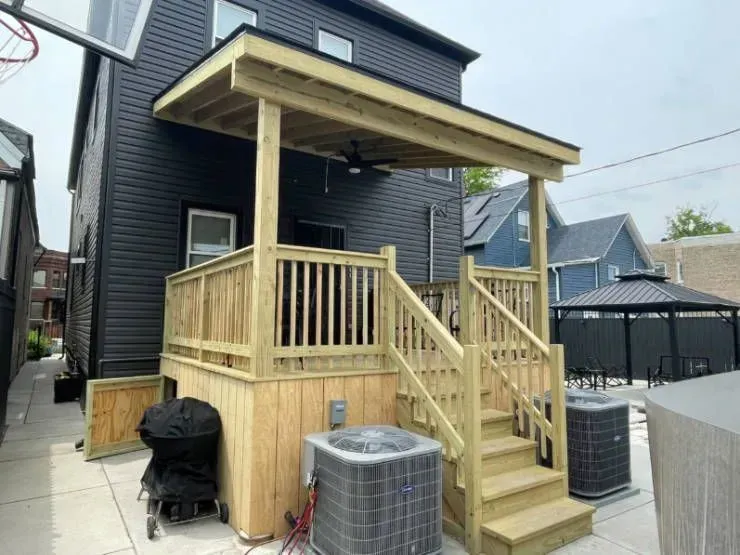 A garage with two cars parked in front of it.