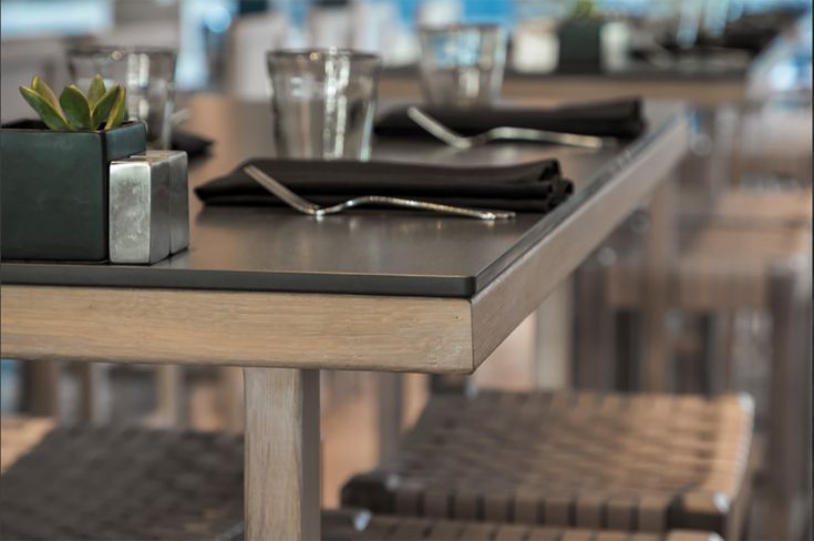 A table in a restaurant with glasses and utensils on it