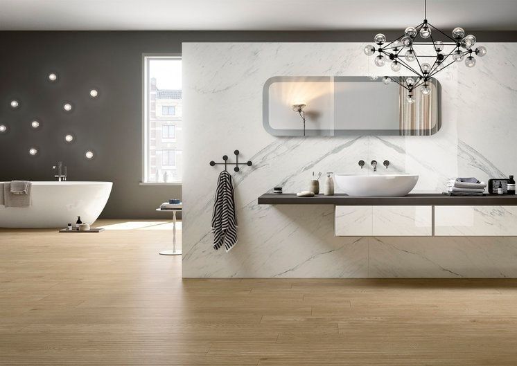 A bathroom with a sink, bathtub and mirror