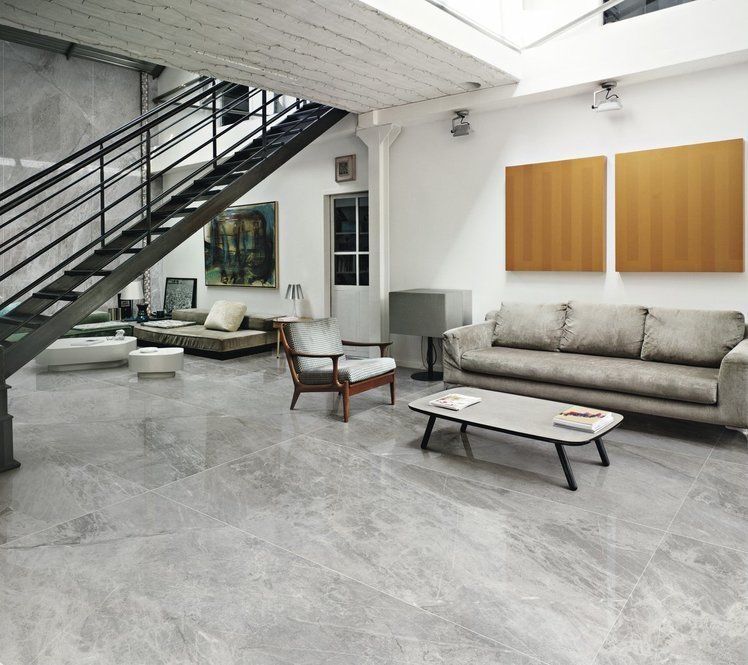 A living room with a staircase leading up to the second floor