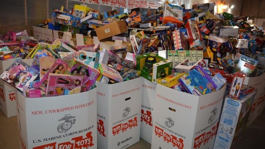 Large boxes overflowing with new, unwrapped toys for a Toys for Tots charity drive during the Seattle holiday season.