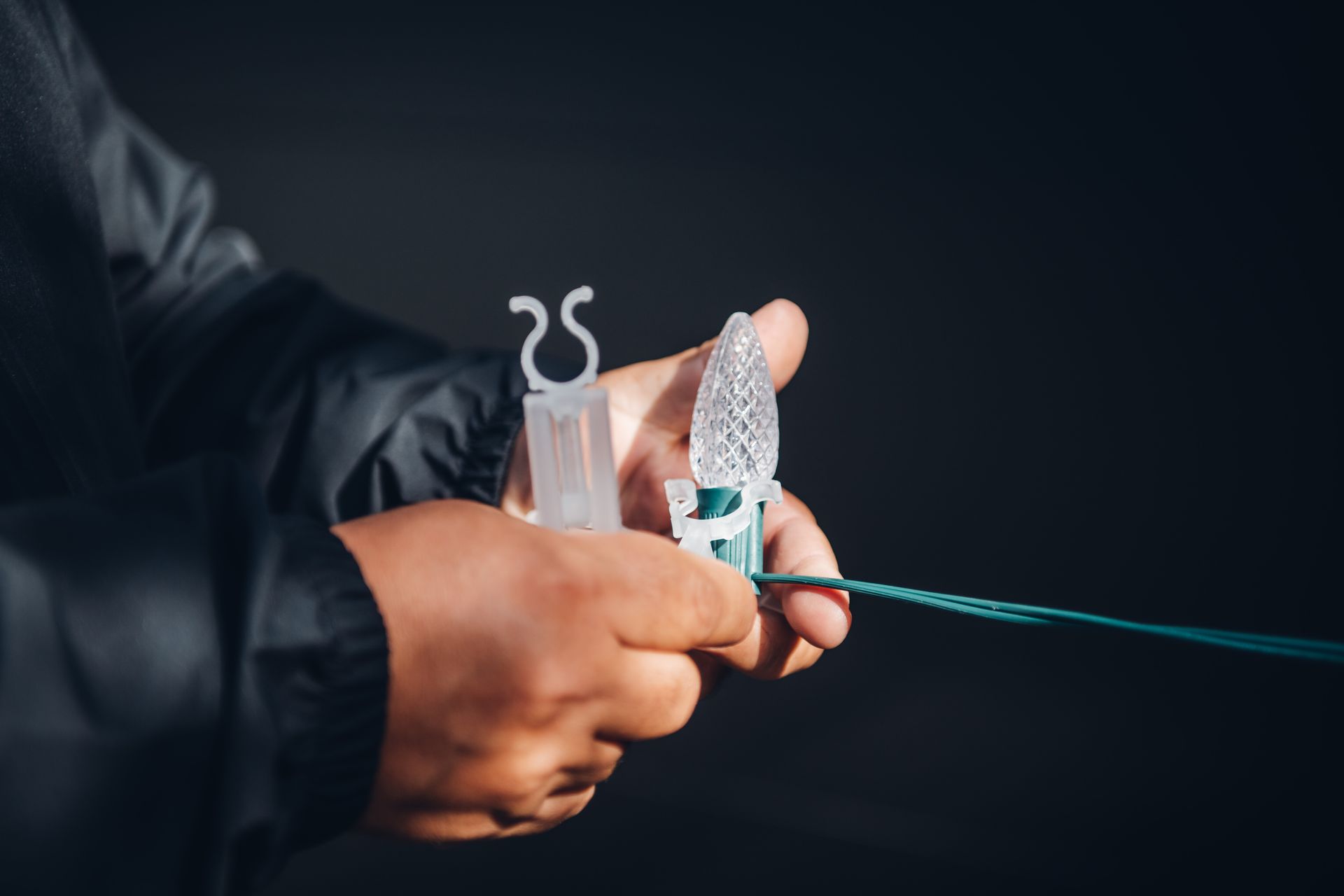 A person is holding a string of lights in their hands.