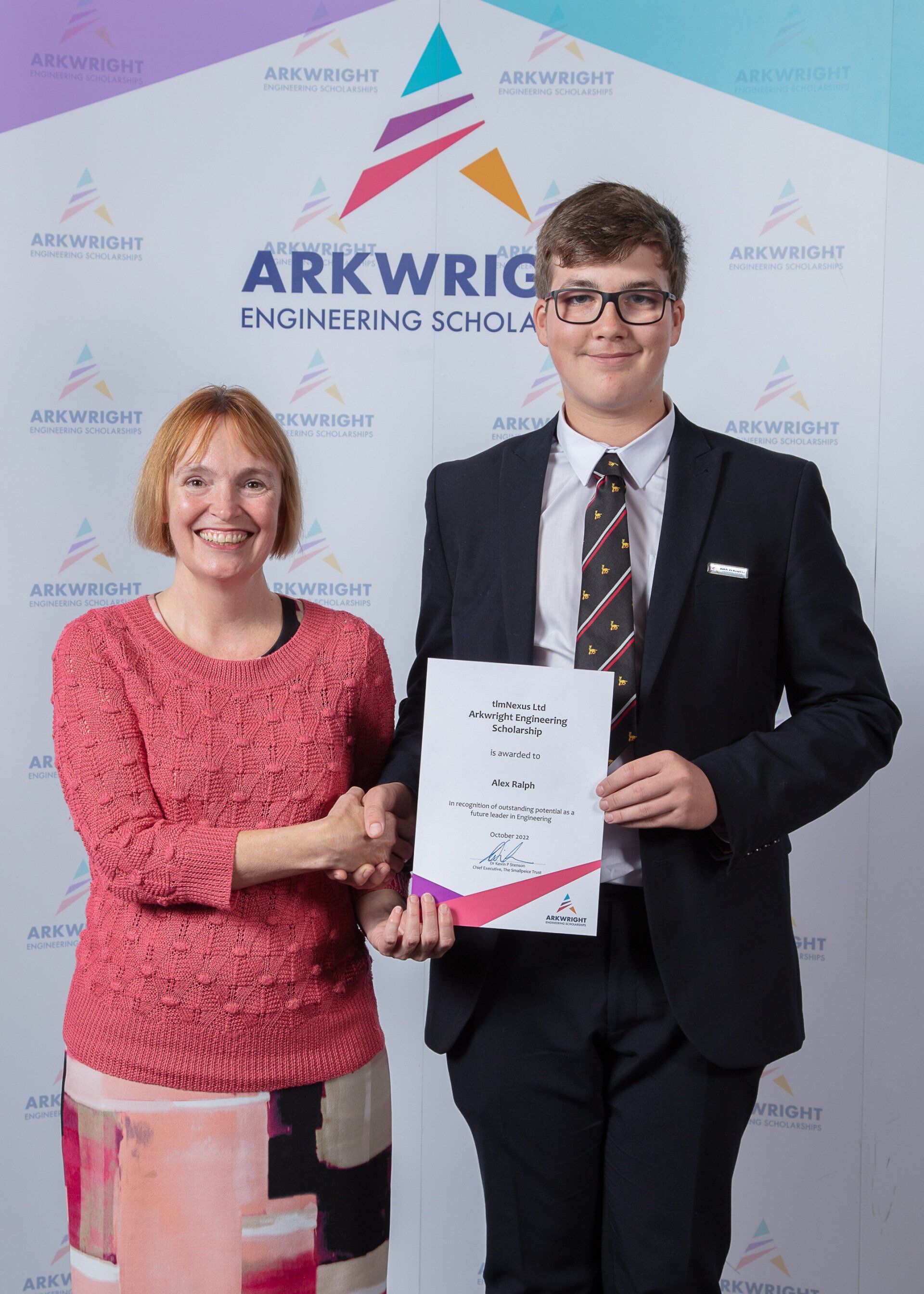 A woman and a young man holding a certificate