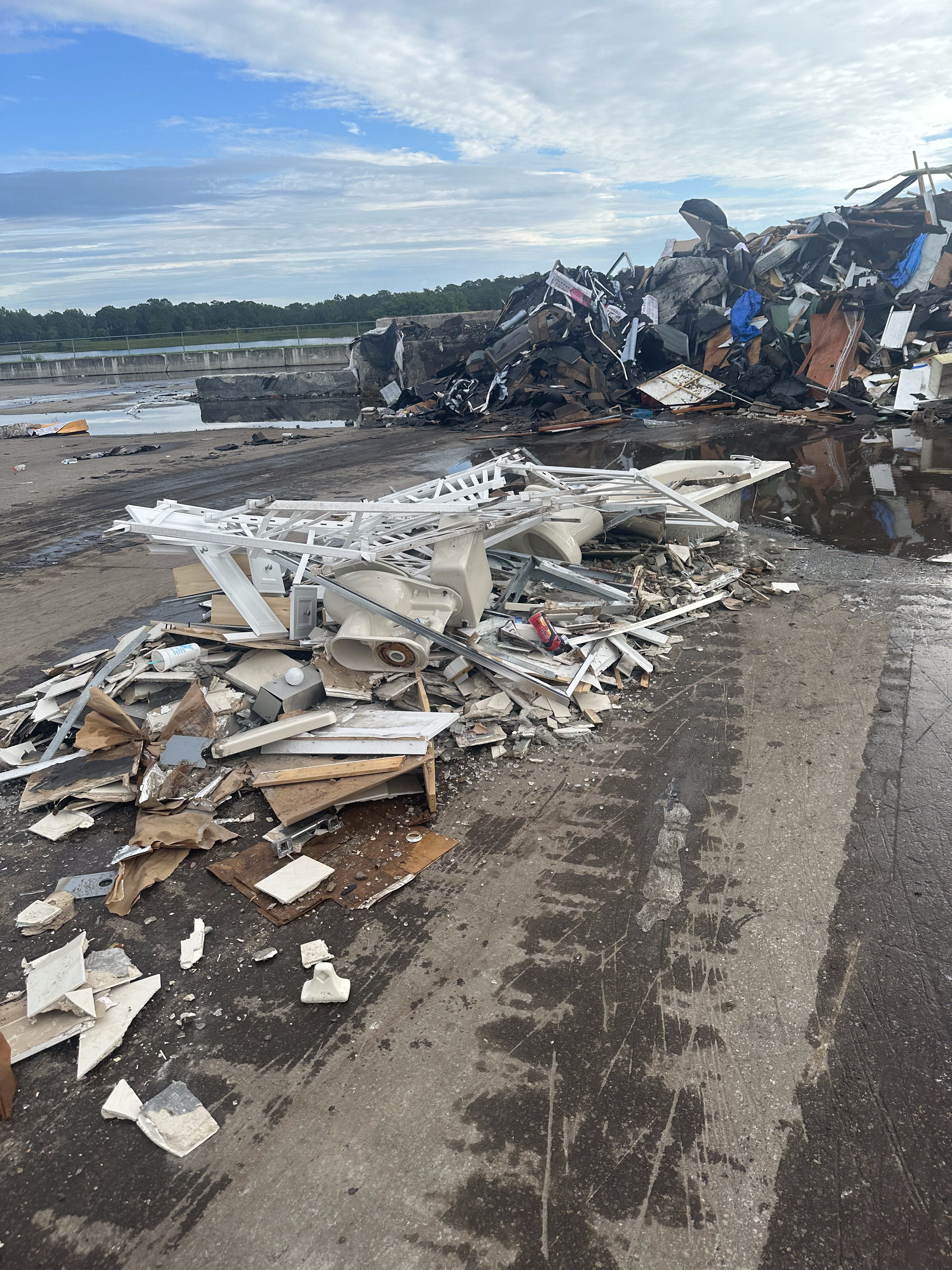 A pile of trash is sitting on the side of a road.