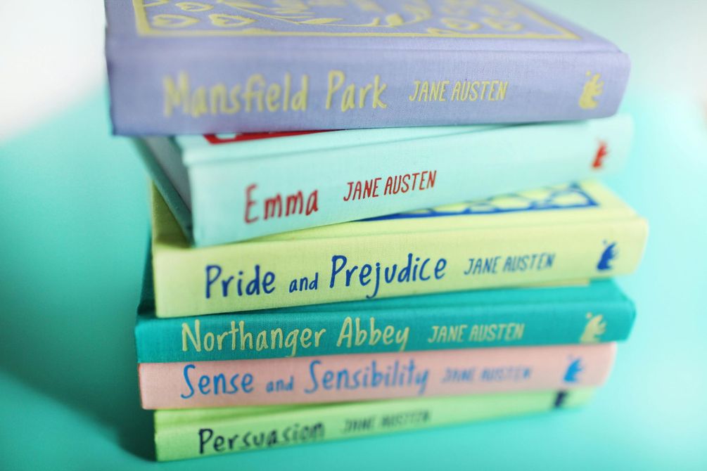 Stack of Jane Austen books with colorful covers.