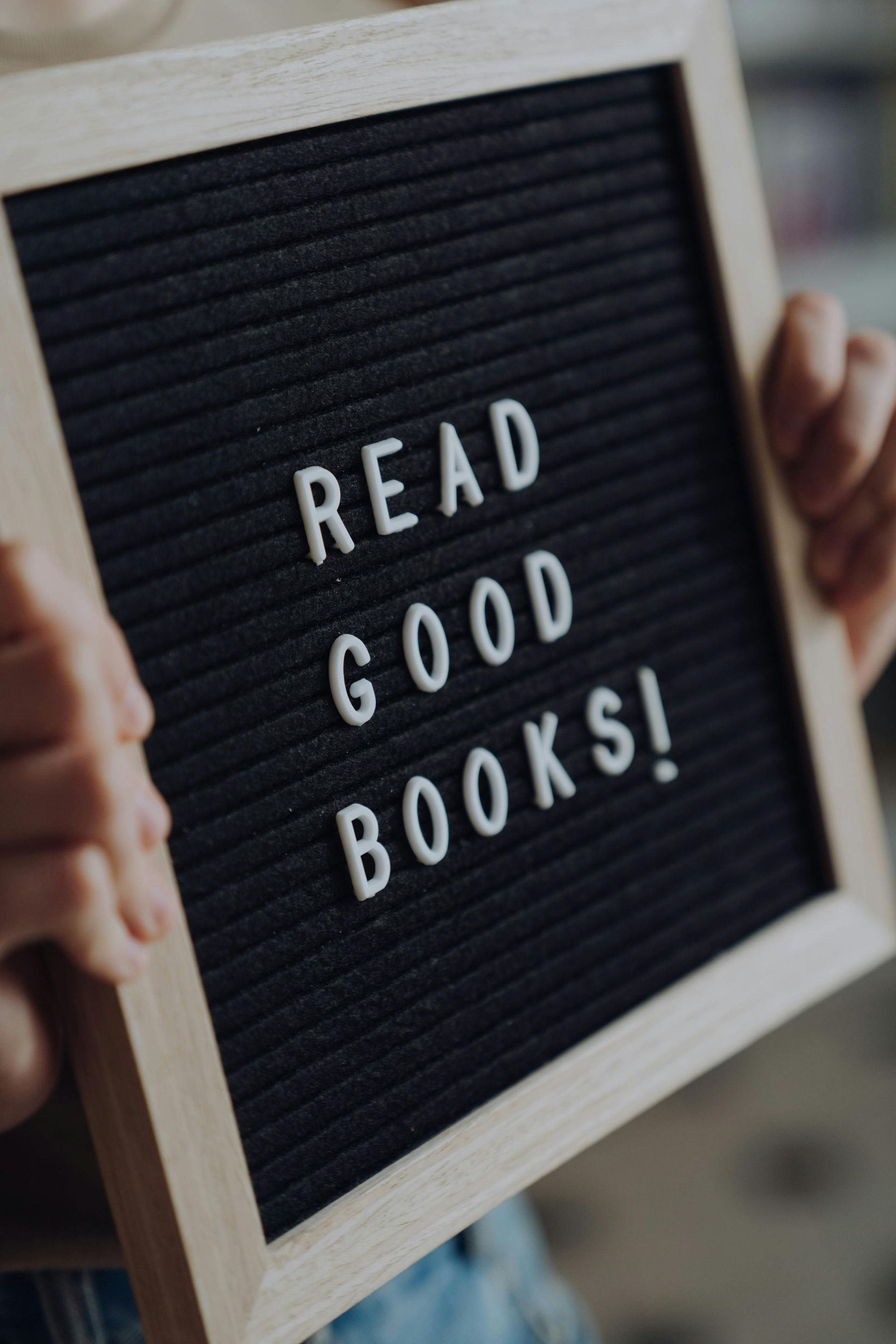Person holding a letter board that says