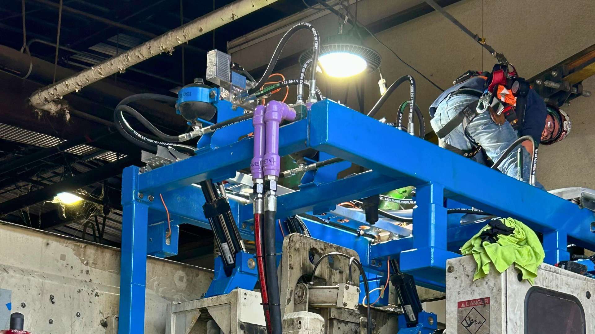 a man is working on a machine in a factory .