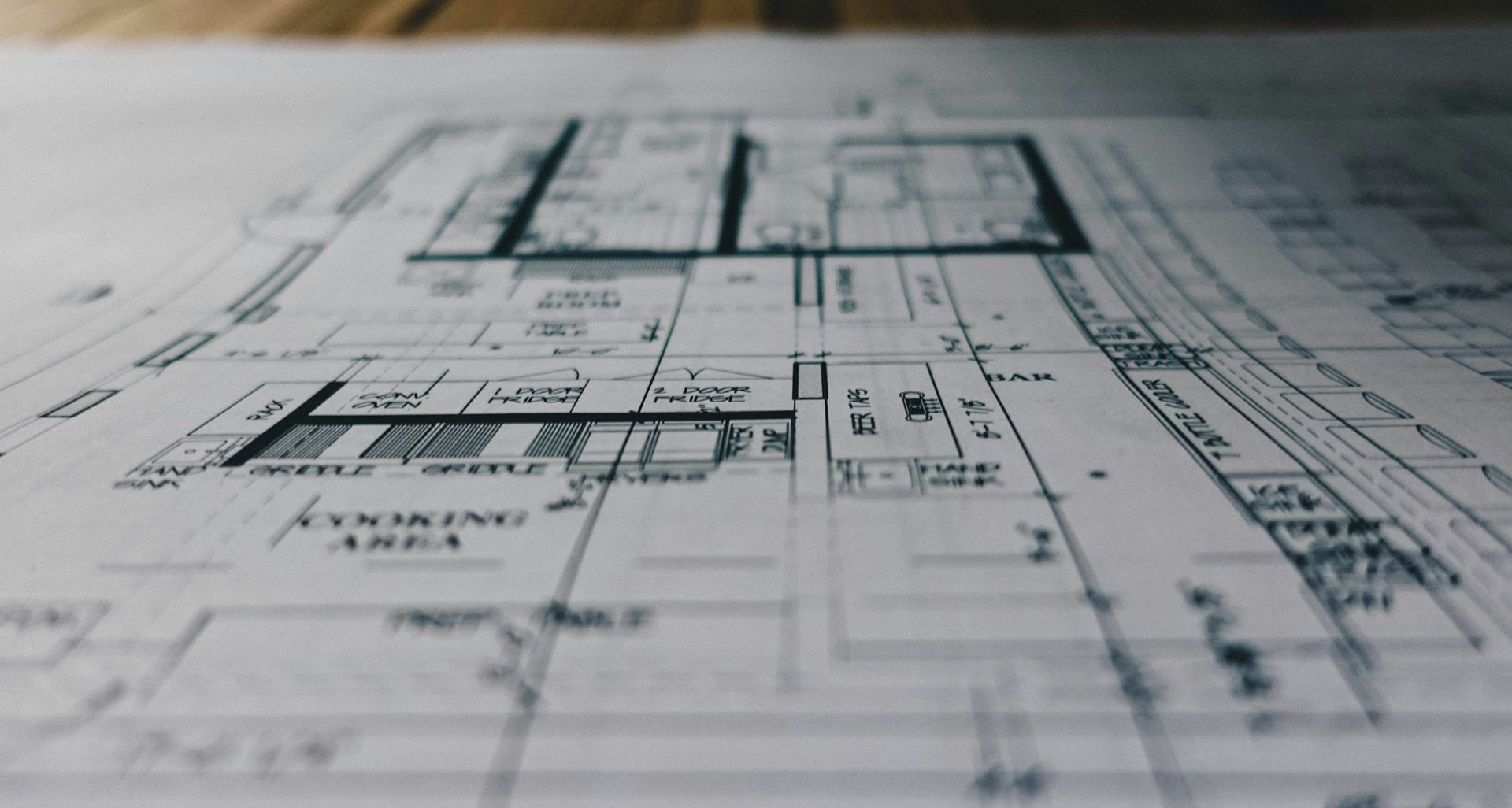 Architectural blueprint on paper, viewed close up with technical floor plan lines and measurements